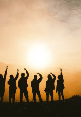 Silhouette of people in a line on a mountain